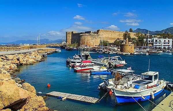 Kyrenia ("Girne" in Turkish) is a city on the northern coast of Cyprus.  A market center and seaside resort, its horseshoe-shaped harbor is flanked by a 12th-century castle fortress.