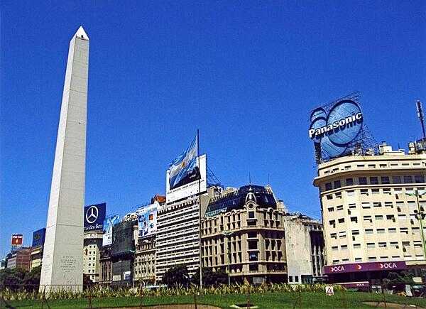 The Obelisk (El Obelisco) along Avenida 9 de Julio in Buenos Aires. The thoroughfare, named after Argentina's independence day (9 July 1816), is generally considered the widest avenue in the world. The Obelisk, built in 1936, measures 67 meters high (220 feet) and commemorates the founding of the city.
