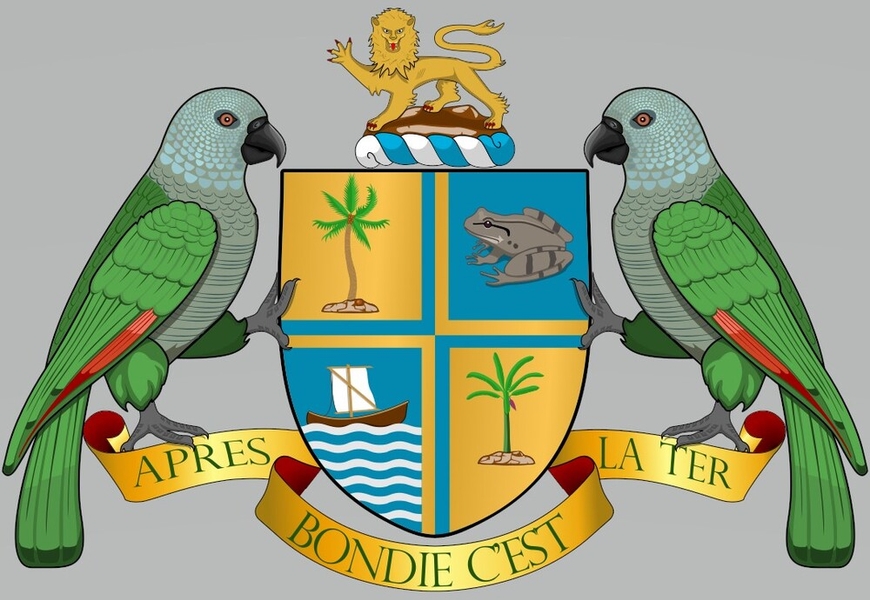 Dominica’s coat of arms was adopted on July 21, 1961, and features two sisserou parrots supporting a shield that is divided into four sections by a cross, a reference to the island’s discovery on a Sunday. The quadrants feature a palm tree, a banana tree, a frog that is native to the island, and a canoe on the Caribbean Sea. The golden lion symbolizes Dominica’s past colonial ties with the United Kingdom. Below the shield is the national motto, which means "After God is the Earth."