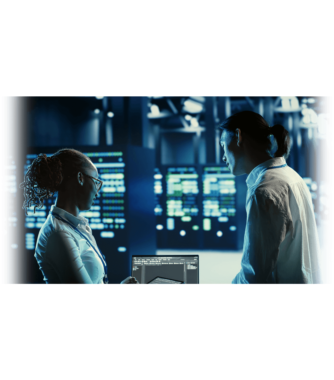 two people talking in front of computer screens