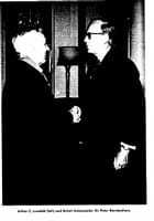 Black and white photo of two men shaking hands.