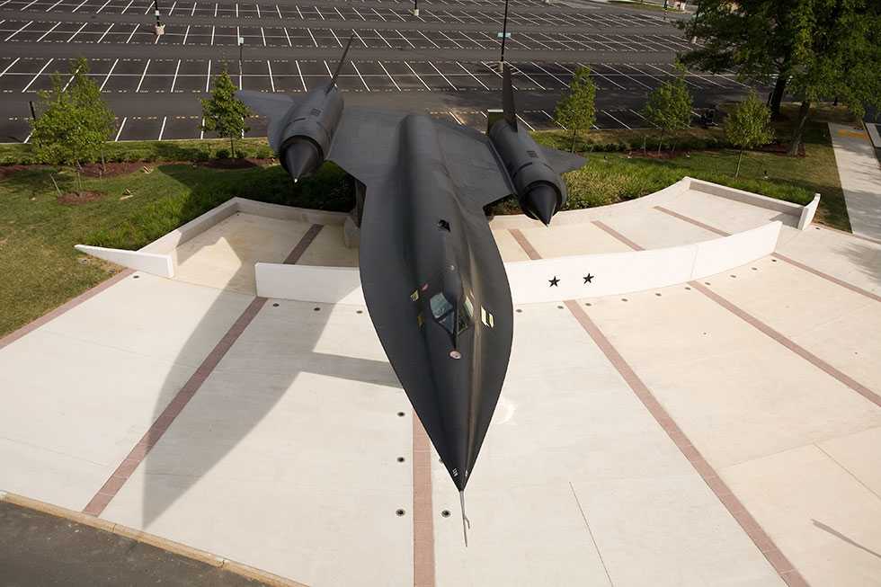 An overhead shot of a black A-12 Oxcart on display at CIA Headquarters in the daytime.