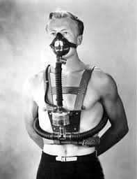 A black and white photograph of Dr. Christian Lambertsen modeling his underwater breathing apparatus.