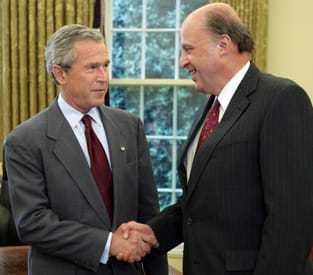 Director of National Intelligence (DNI) John Negroponte shaking hands with President George W. Bush.