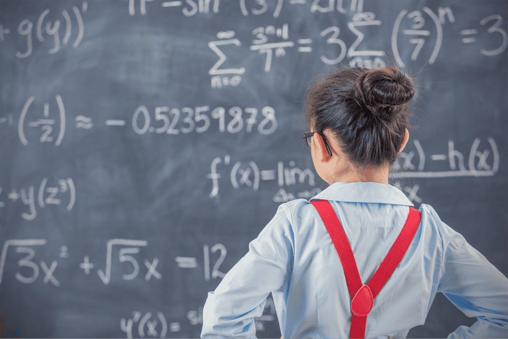 young female student in front of chalkboard