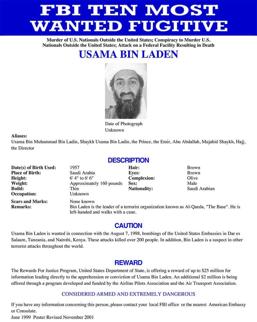 A white poster headlined, "FBI Ten Most Wanted Fugitive," with an image and description of Usama Bin Laden.