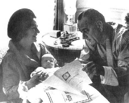 FDR reading the PDB beside his wife and baby.