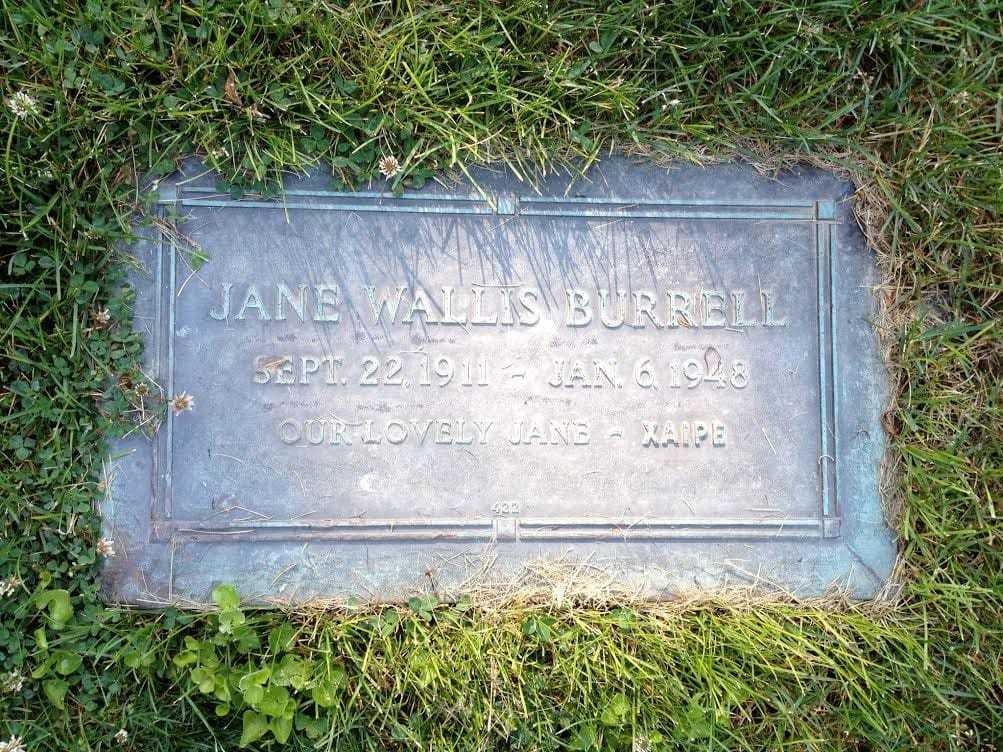 A color photograph of Jane's tombstone plaque with her name and date of death inscribed.