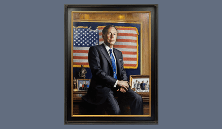 A portrait of former CIA director David H. Petraeus in a dark wood frame.