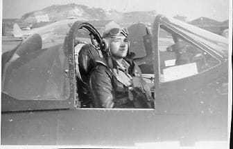 Black and white image of Norman Schwartz in an airplane