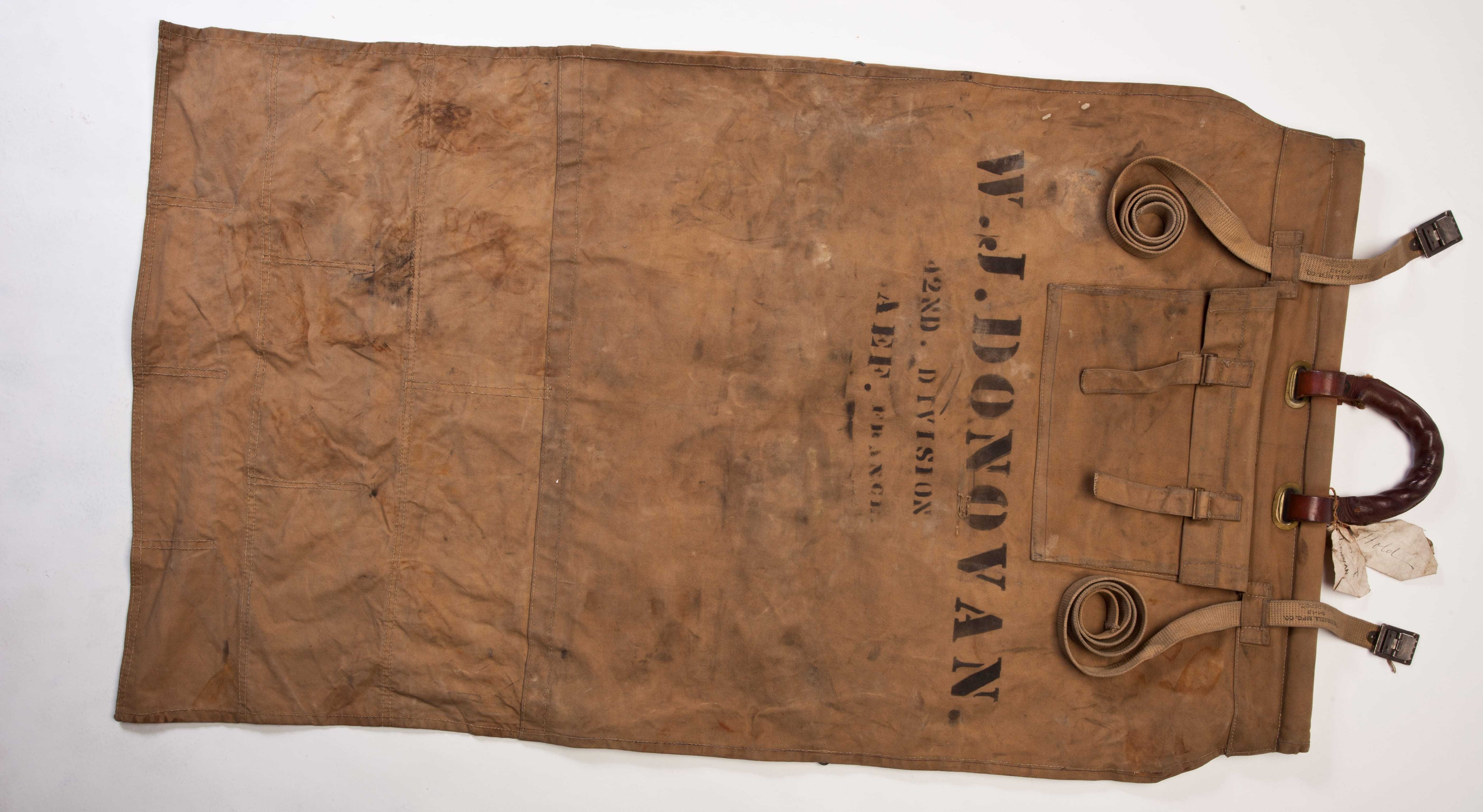 A canvas bag with straps and handles and "W.J. Donovan" printed on the side.