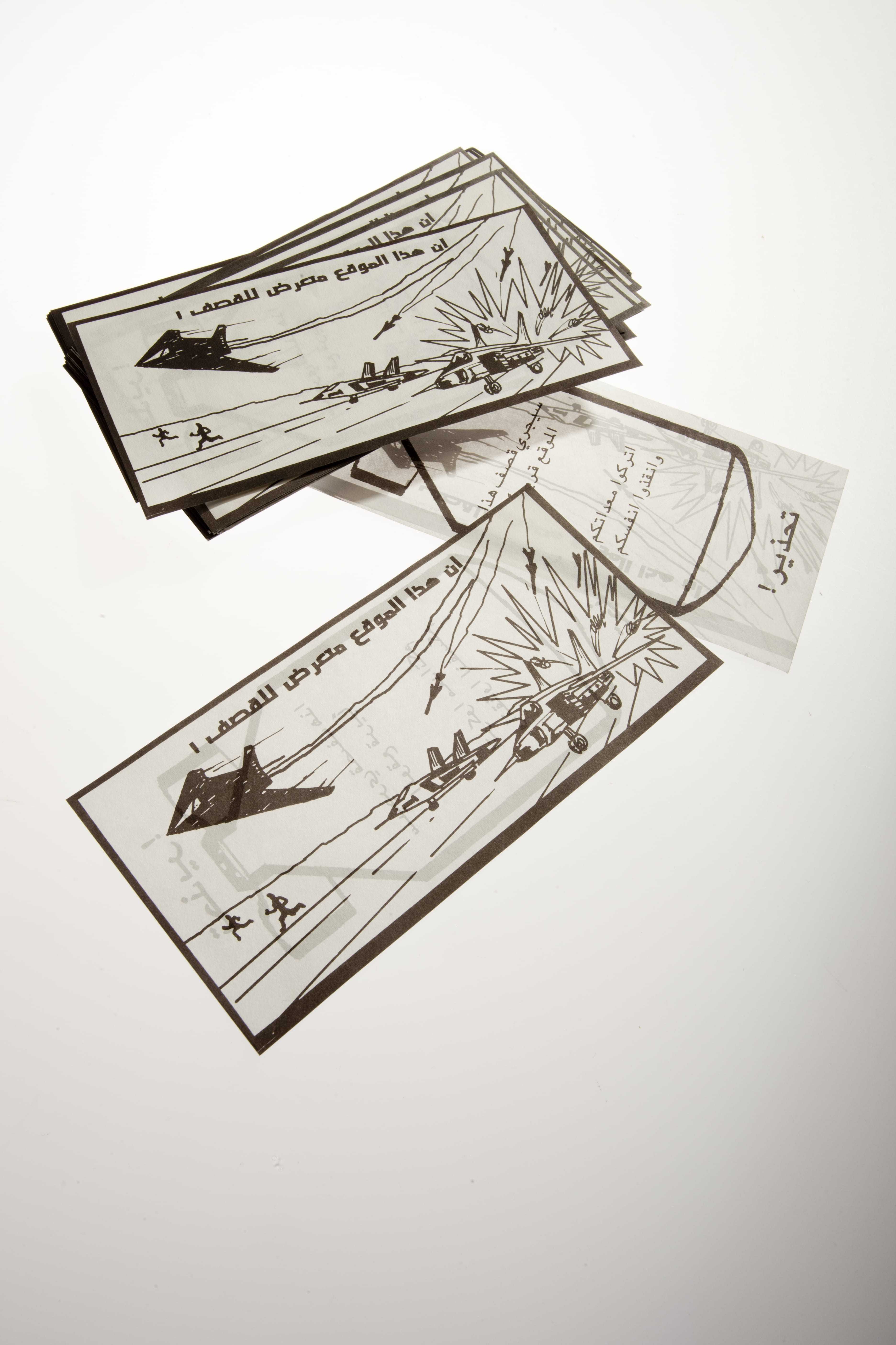 White rectangular leaflets with brown borders depicting military air strikes. The text contains warnings about the air strikes.