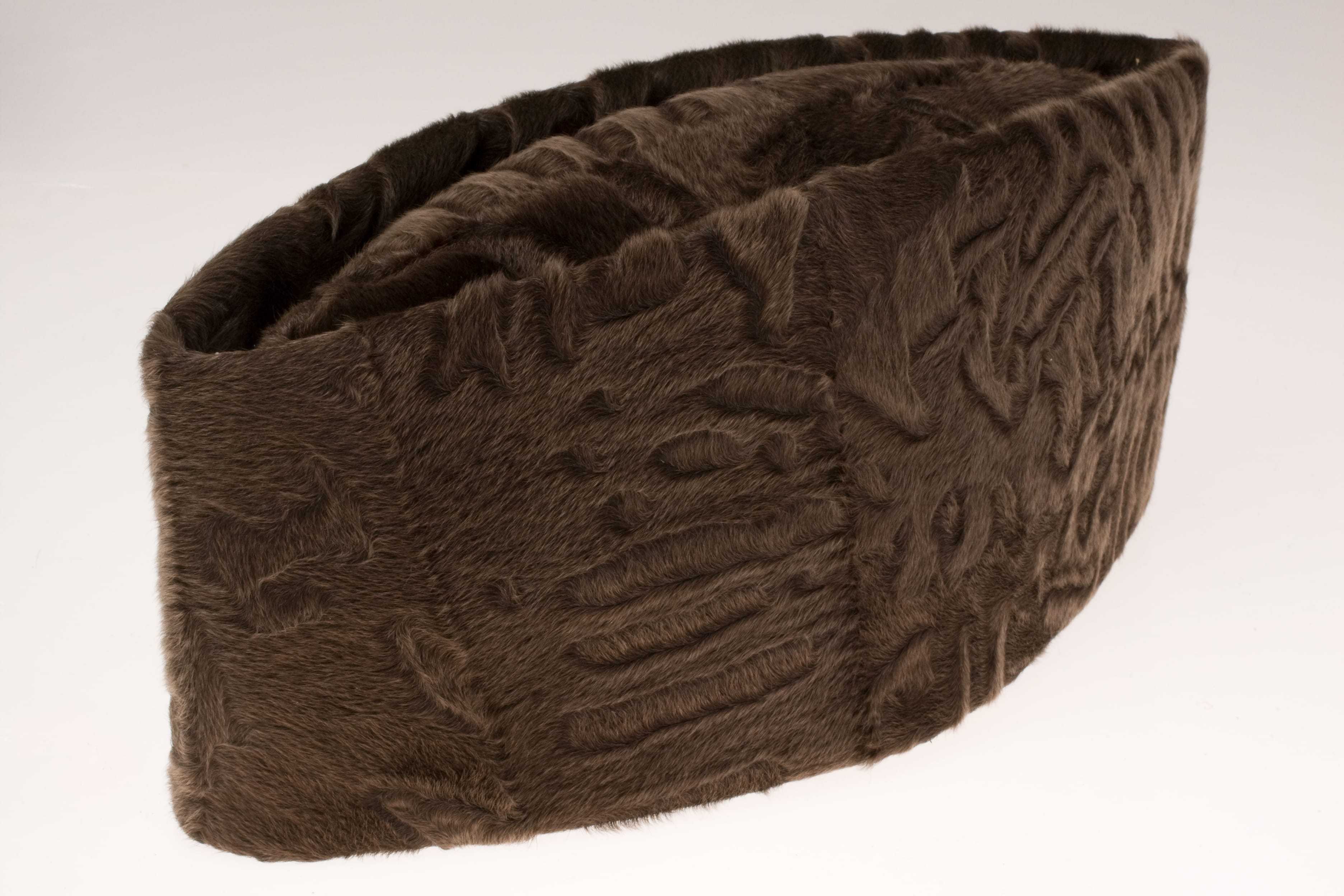 A short round hat, made of a furry brown material