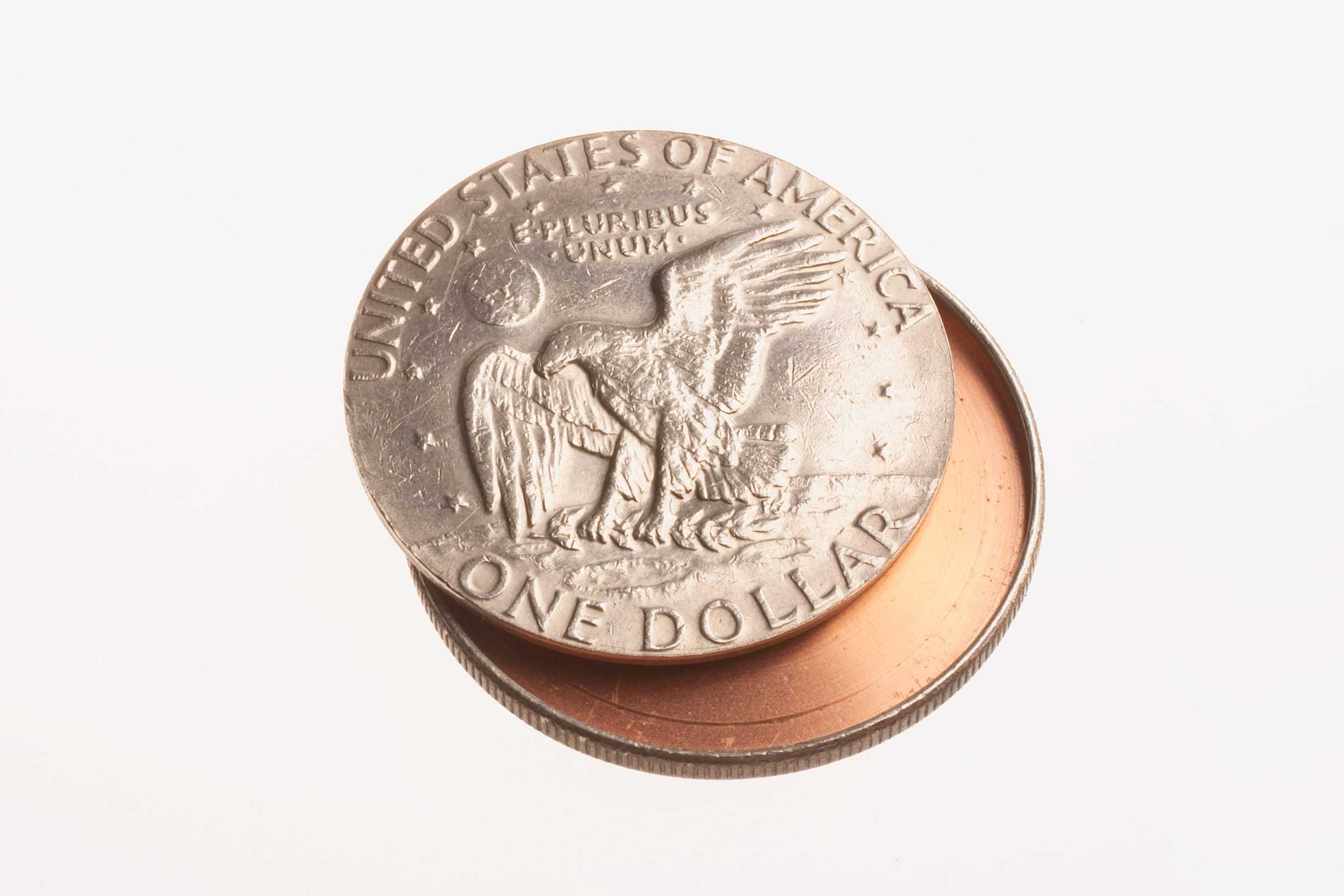 A hollow container disguised as an Eisenhower silver dollar that can conceal messages or film