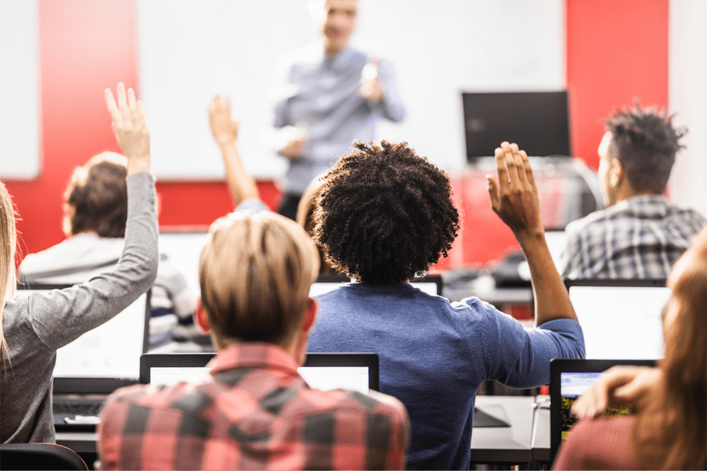 student raising hand in class