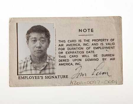 The reverse side of the Air America ID Card, with a picture and signature of Tom Lum.