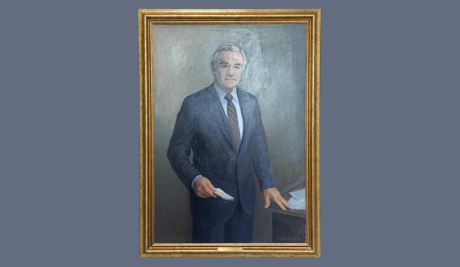 A portrait of former CIA director Admiral Stansfield Turner in a gold frame.
