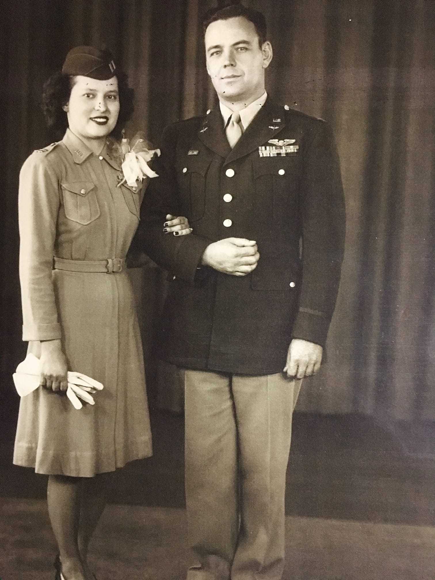 An old photograph of Stephanie leaning on the shoulder of a man in military uniform.