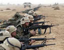 An image of military men with rifles in laying in a row during Operation ENDURING FREEDOM.