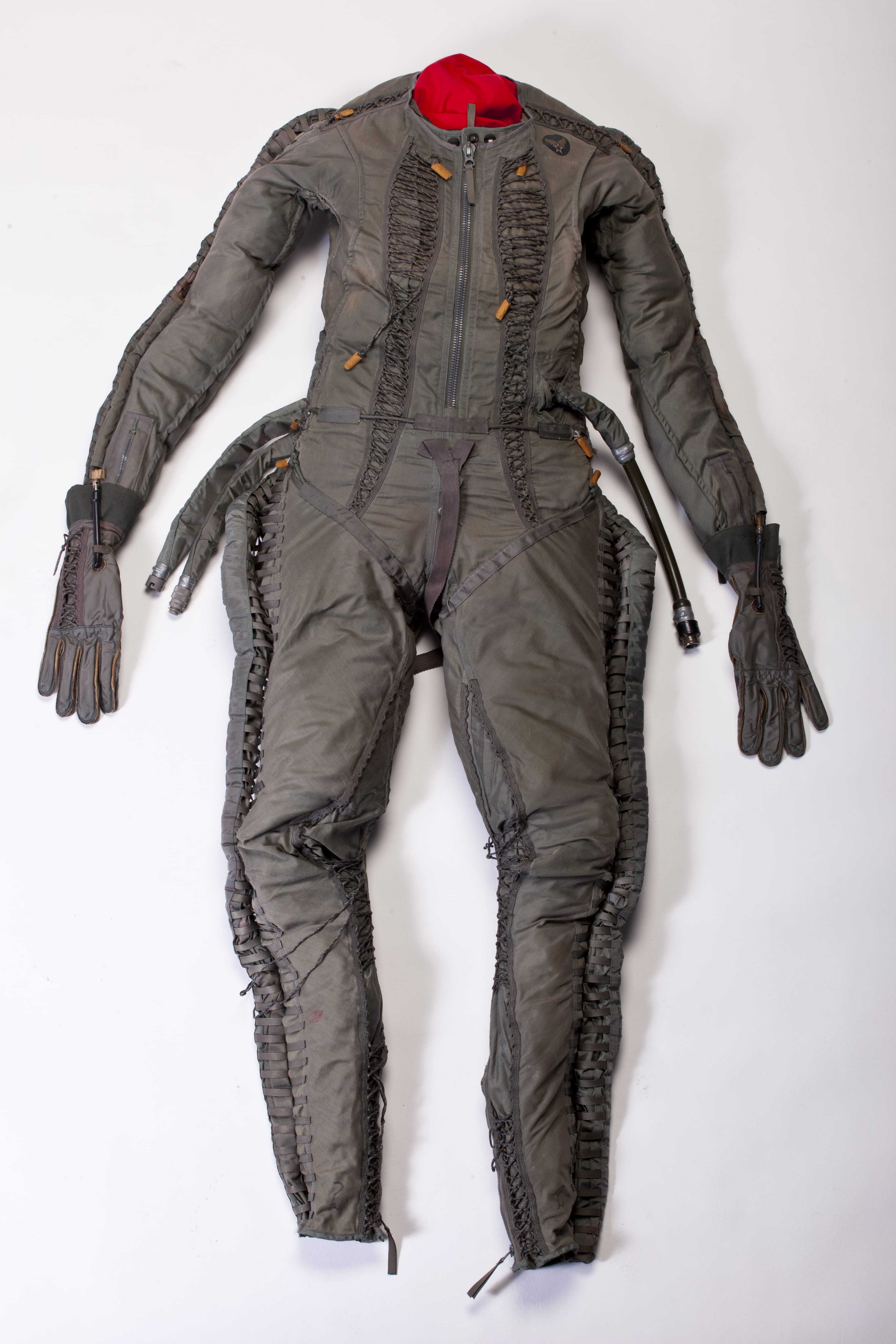 A grey bodysuit with gloves and hose attachments.