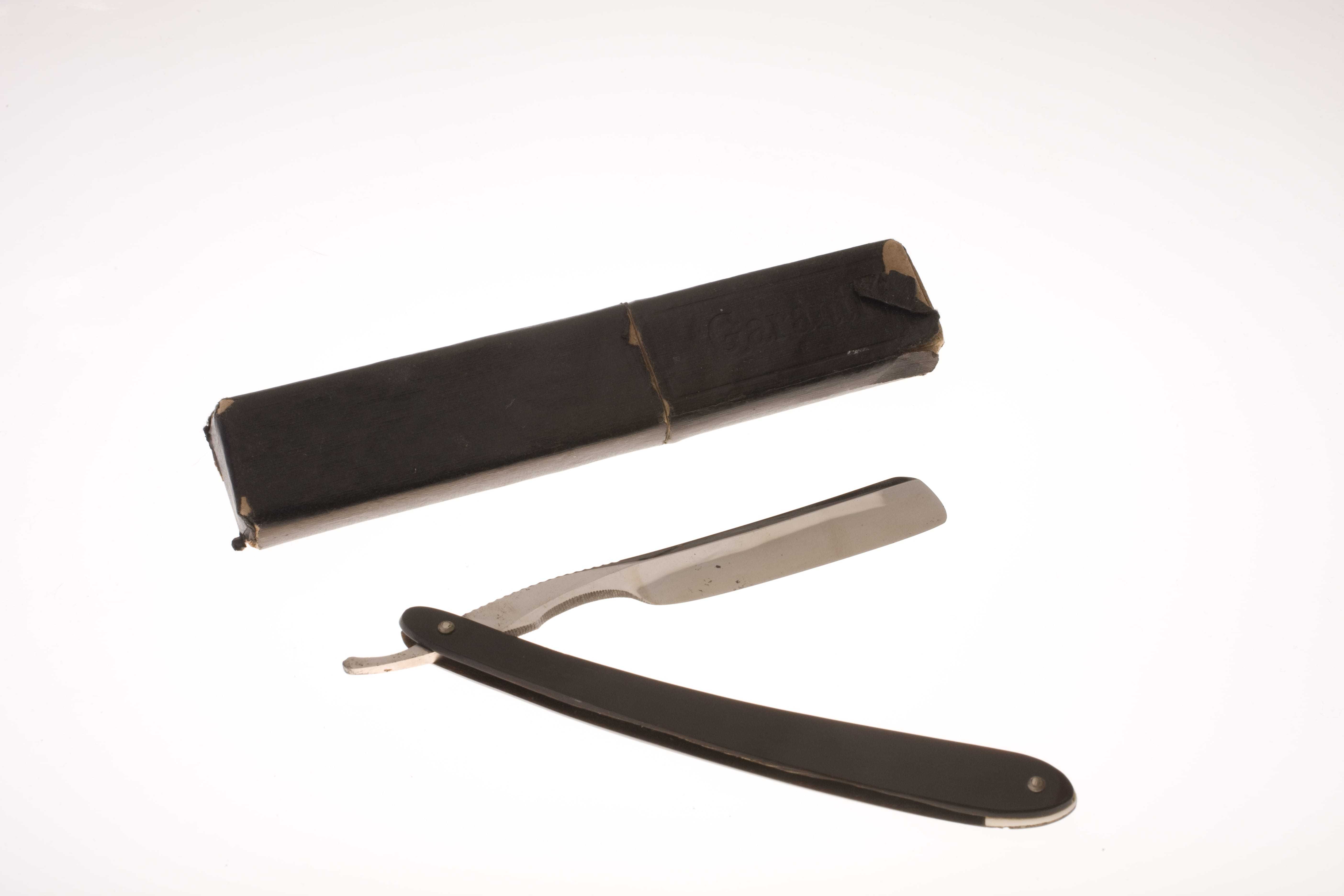 A shaving razor with a slim brown handle and a brown case