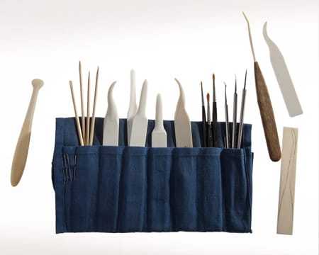 A blue fabric tool kit filled with various tools.