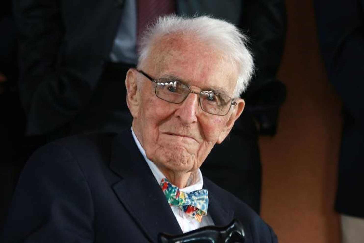 An older Fisher Howe with glasses, a suite, and bow tie looking at the camera.