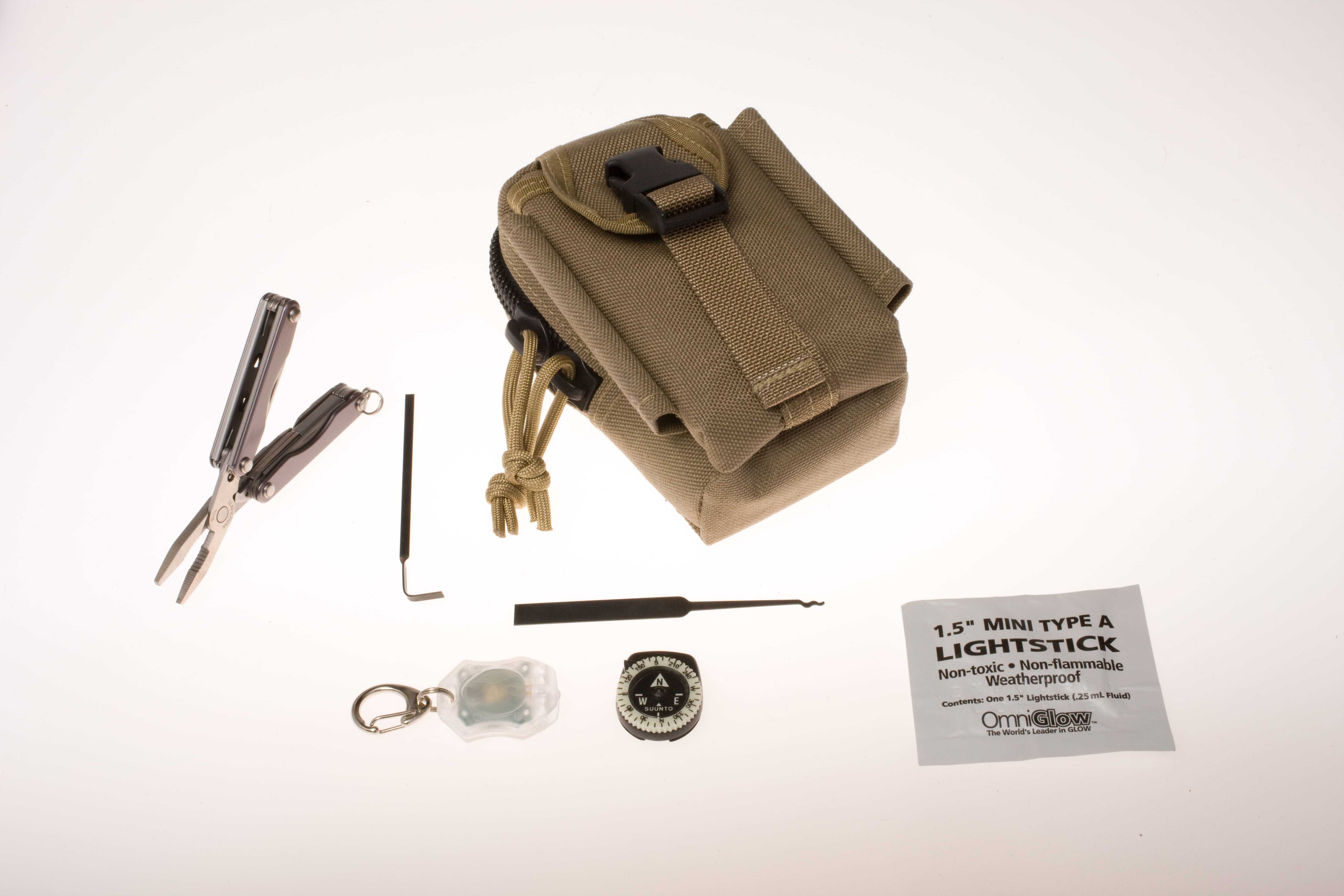 A small bag surrounded by wire cutters, a light stick, and other small survival tools