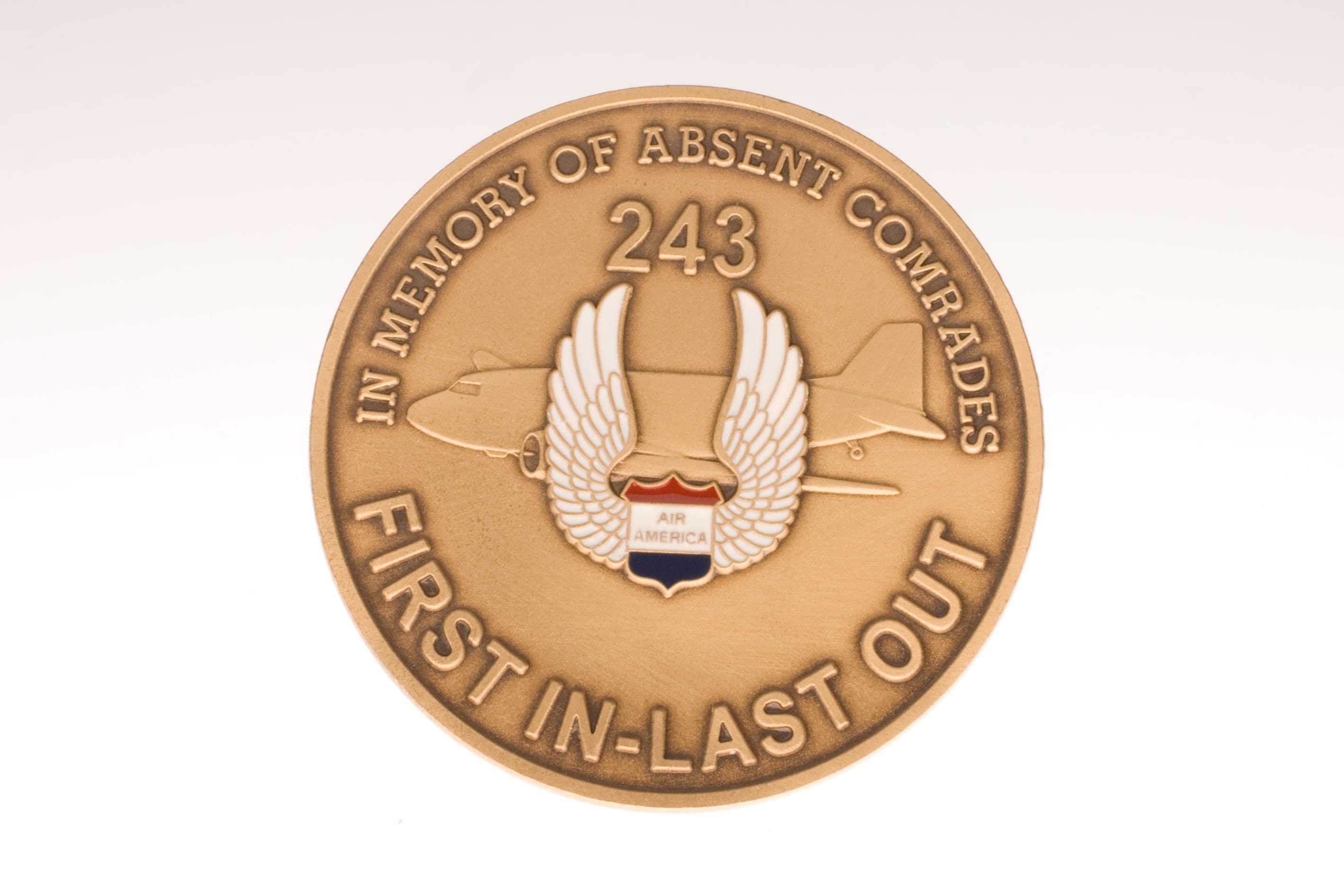 An Air America coin memorializing lost fighters, with the words "First in-last out