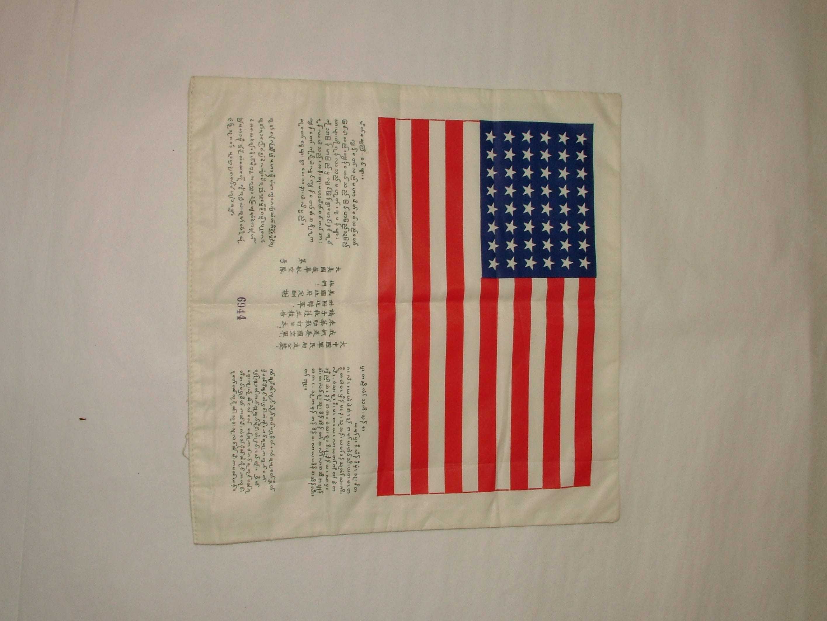 A piece of paper, with an American flag across the top and the same message in multiple languages beneath
