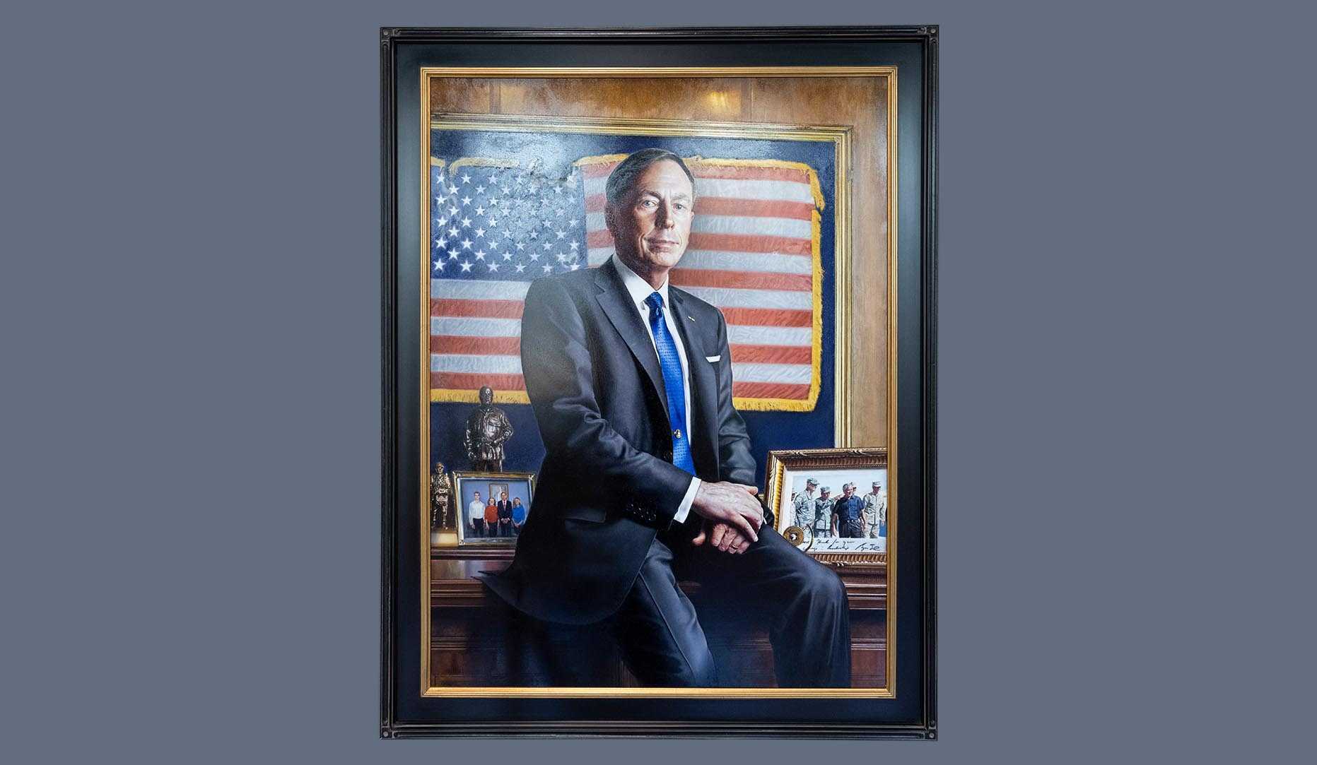 A portrait of former CIA director David H. Petraeus in a dark wood frame.