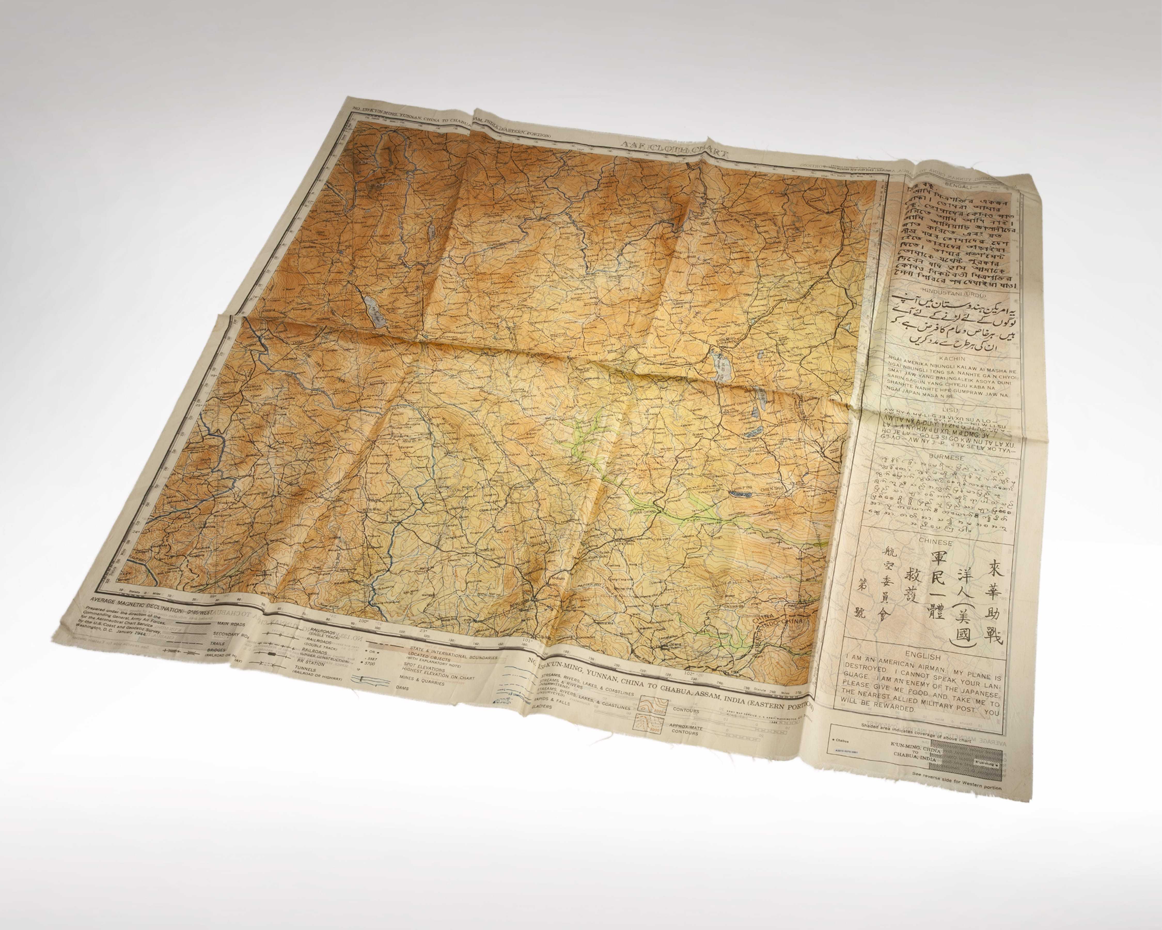 A large map printed on silk with information in multiple languages printed alongside