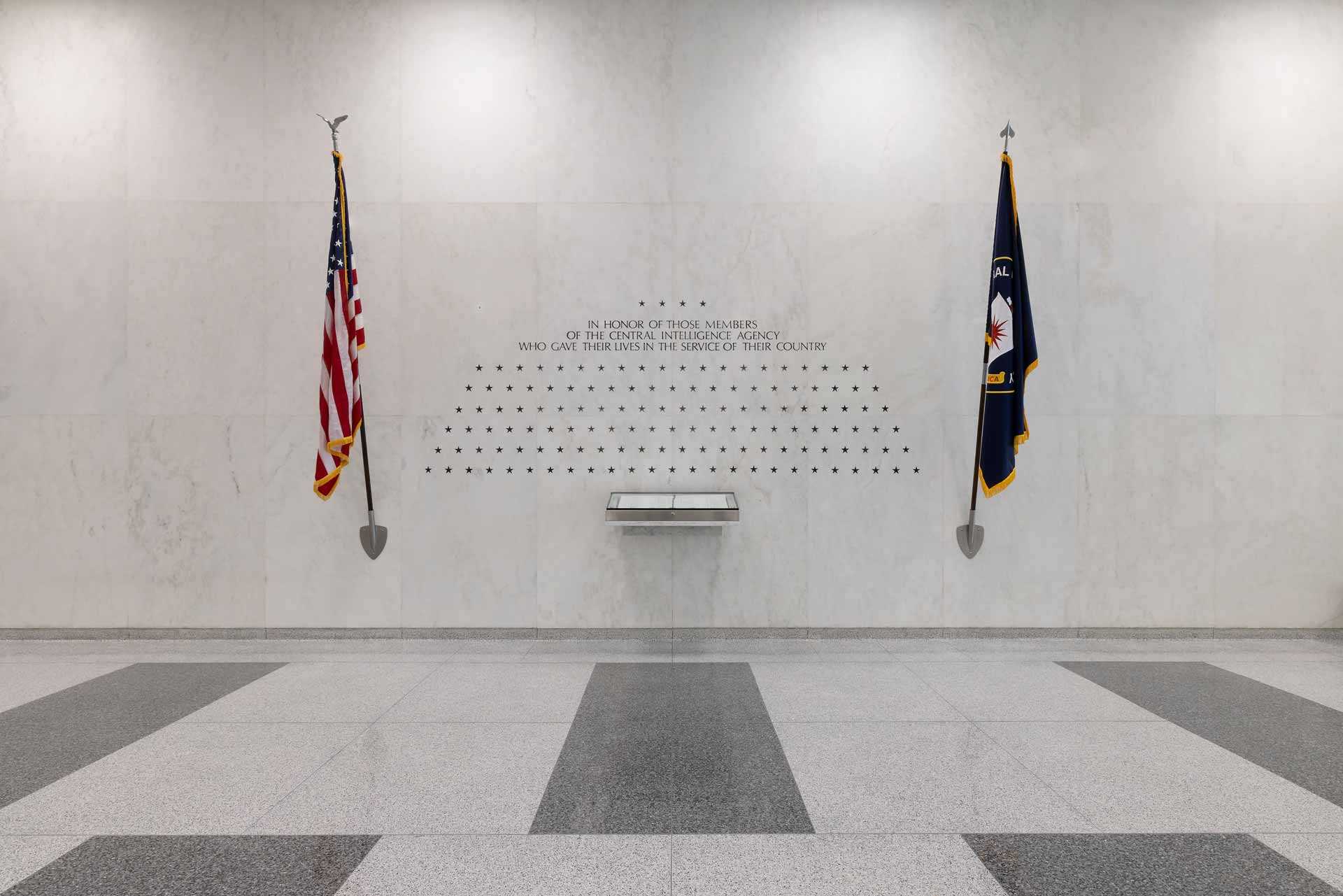 The American flag and the CIA flag on either side of an inscription with 139 stars engraved.