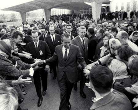 President Nixon shaking hands in a crowd of people.