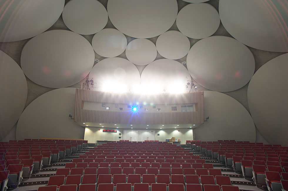 A rear stage-view of the theater inside the CIA Headquarters Auditorium, with stage lights turned on.