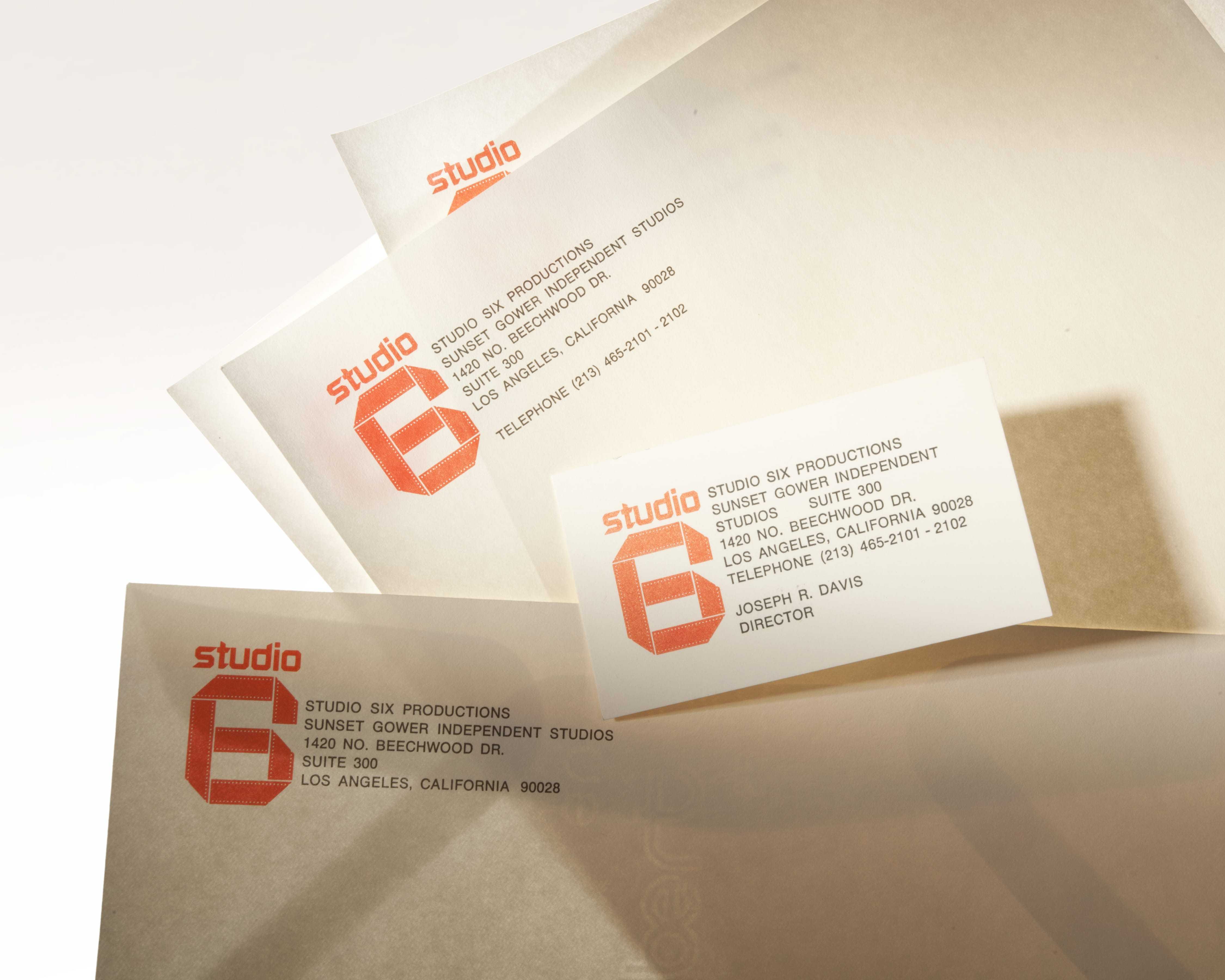 Business cards with the Studio Six logo and information