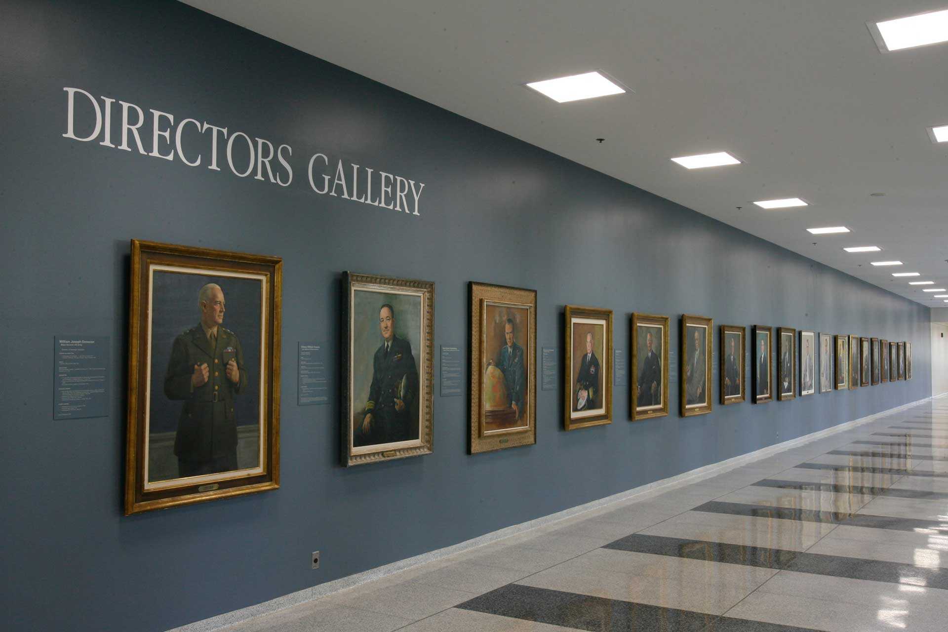 A wall at the CIA museum featuring a portrait gallery of former CIA directors.