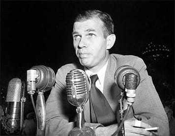 Image of Alger Hiss with microphones in front of him.