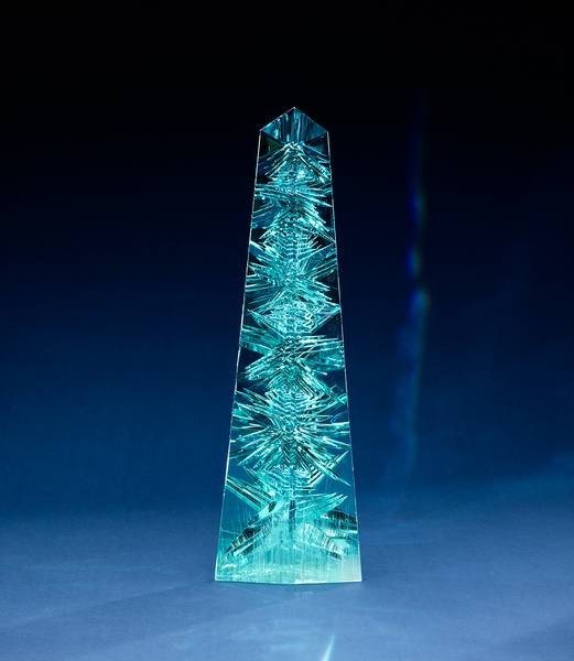 Aquamarine, often called the treasure of mermaids, is mostly found and mined in Brazil, as well as countries that fall along the Mozambique geological belt in Africa. The biggest aquamarine ever found was in Brazil in 1910, it weighed 110 kg ( 243 lb) and was cut into smaller faceted stones for jewelry. The “Dom Pedro,” the largest single piece of cut-gem aquamarine in the world, was found in a Brazilian pegmatite mine in the late 1980s and is named after Brazil’s first two emperors (both named Pedro). The original crystal weighed roughly 45 kg (100 lb), but during excavation it shattered into three pieces. The largest section, approximately 27 kg (60 lb), was sculpted into an obelisk shape. The obelisk, 35.5 cm (14 in) tall, measuring 10 cm (4 in) across the base and weighing 10,363 carats or 2.1 kg (4.6 lbs), is part of the permanent collection of Smithsonian National Museum of Natural History in Washington, DC. Photo courtesy of the Smithsonian/ Greg Polley.