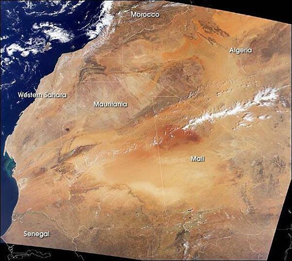 A remarkably clear satellite image of northwestern Africa vividly displays the extent of the Sahara. To the north are the dark brown Atlas Mountains of Morocco, to the west is the Atlantic Ocean, and to the south is the semi-arid (light brown) Sahelian region. Mali extends across the arid desert, through the Sahelian region, and into a fertile southern Sudanese region. Photo courtesy of NASA.