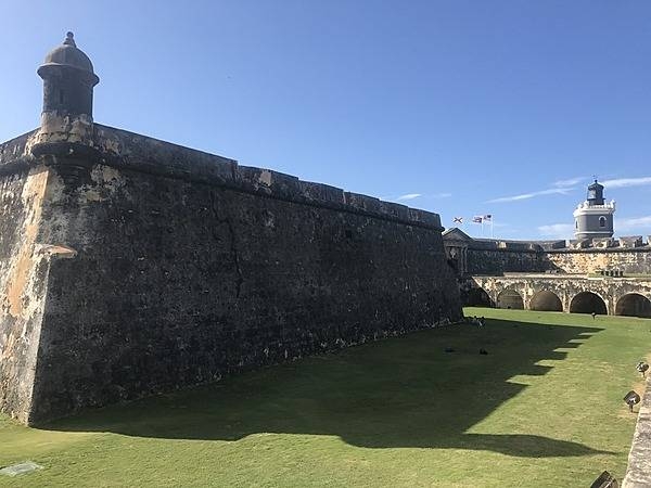 Wall and garita shadows fill up most of a dry moat at the Castillo San Felipe del Morro in San Juan. Photo courtesy of the US National Park Service/ Casey Ogden.