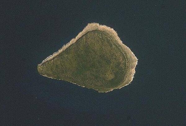 Astronaut photo of teardrop-shaped Navassa Island. The island is basically a plateau encircled by fairly steep cliffs. Image courtesy of NASA.