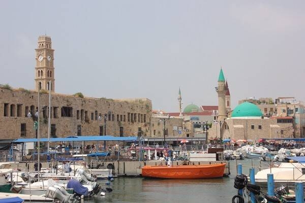 Acre, known locally as Akko, is located in a harbor of Haifa Bay on the coast of the Mediterranean; it is considered among the oldest continuously-inhabited settlements in the world. Acre is one of the holiest cities of the Baháʼí Faith and receives many pilgrim visitors. In 1750, Zahir al-Umar, the ruler of Acre, utilized the remnants of the Crusader walls as a foundation for defensive fortifications. Today, the reinforced sea walls remain mostly intact. Acre's Old City has been designated by UNESCO as a World Heritage Site.