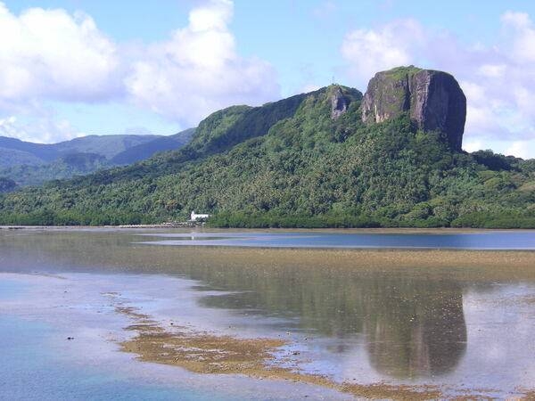 A view of Paipalap Peak (Sokehs Rock) overlooking Pohnpei harbor. The rock, rising over 186 meters, is a basalt volcanic plug. This prominent feature is sometimes referred to as the "Diamondhead" of Micronesia.