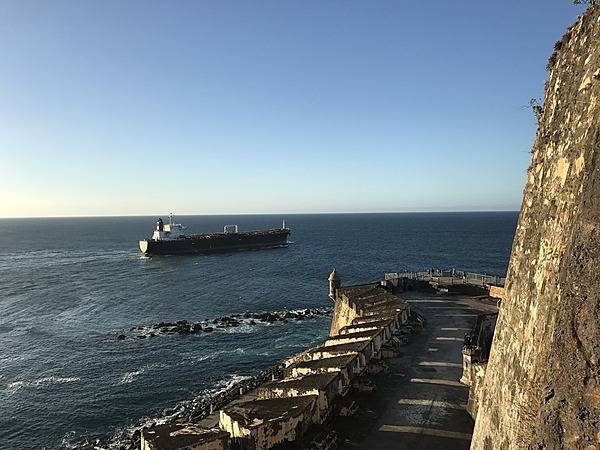 A ship crossing the entrance to San Juan Bay. From the 1500s to today, all ships entering or exiting the bay must pass in front of the mighty walls of the Castillo San Felipe del Morro. Photo courtesy of the US National Park Service/ Casey Ogden.