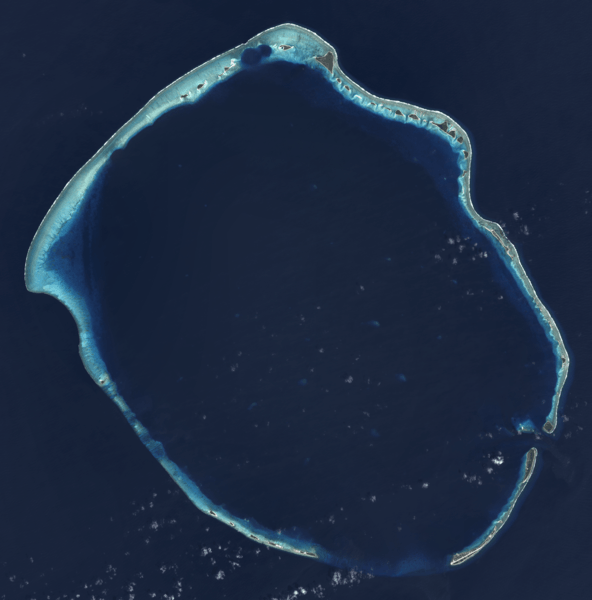 Satellite image of Enewetak Atoll. Enewetak Island after which the entire atoll is named is actually the southernmost island at the bottom right. The crater formed by the Ivy Mike nuclear test may be seen near the north cape of the atoll, with the smaller Castle Nectar crater adjoining it. Image courtesy of NASA.