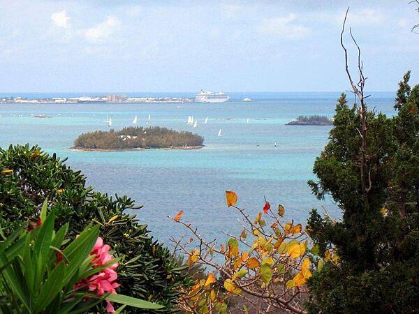 The view east toward King&apos;s Wharf from Gibbs Hill with sailboats and cruise ship in the distance.