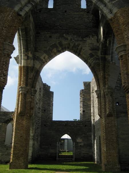 Bermuda’s “Unfinished Church” - what would have been St. George Church - fell victim to three events that precluded its use. The Gothic 650-seat church, designed by William Hay, began construction in 1874 as a replacement for the storm-damaged St. Peter’s church. During the construction the congregation split, which halted work on the church. Funds were later diverted to build a new cathedral in Hamilton after the old one burned down. Private donations finished the church in 1899, but the rejoined congregation returned to old St. Peter’s. In 1926, a storm damaged the church leaving it in its present condition. The “Unfinished Church” is maintained by the Bermuda National Trust.