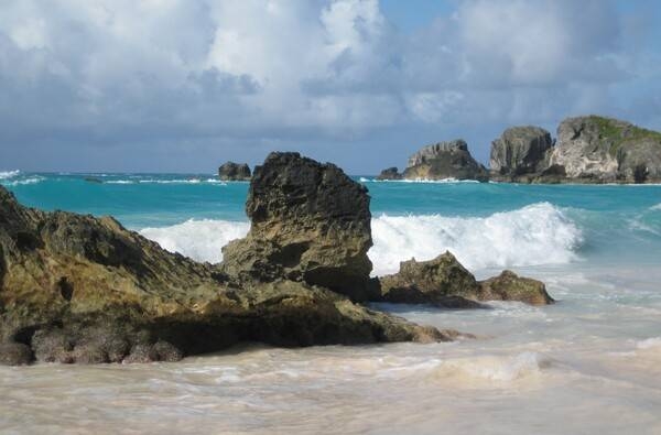 Horseshoe Bay Beach is named for its natural U-shape. The beach, bordered by limestone cliffs, has large reefs as well as the famous Bermuda pink sand (the color derives from crushed shells and coral). Horseshoe Bay Beach is rated one of the most popular beaches in the world to visit and is the most photographed beach in Bermuda.