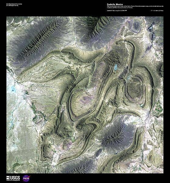 This high-resolution satellite image shows part of the Sierra Madre Oriental mountain range, on the border between the Coahuila and Nuevo Leon provinces of eastern Mexico. This range is part of the Sierra Madre Mountains that divide Mexico, and which also include the Sierra Madre Occidental on the West coast and the Sierra Madre del Sur in southern Mexico. In the area shown, ancient sedimentary rocks were folded as a result of a tectonic collision that some geologists consider related to the Appalachian folding of eastern North America. This mountain range is drier than the rainforest areas to the south. Image courtesy of USGS.